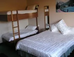 Studios 3 and 4 — motel-style room with queen bed and bunks